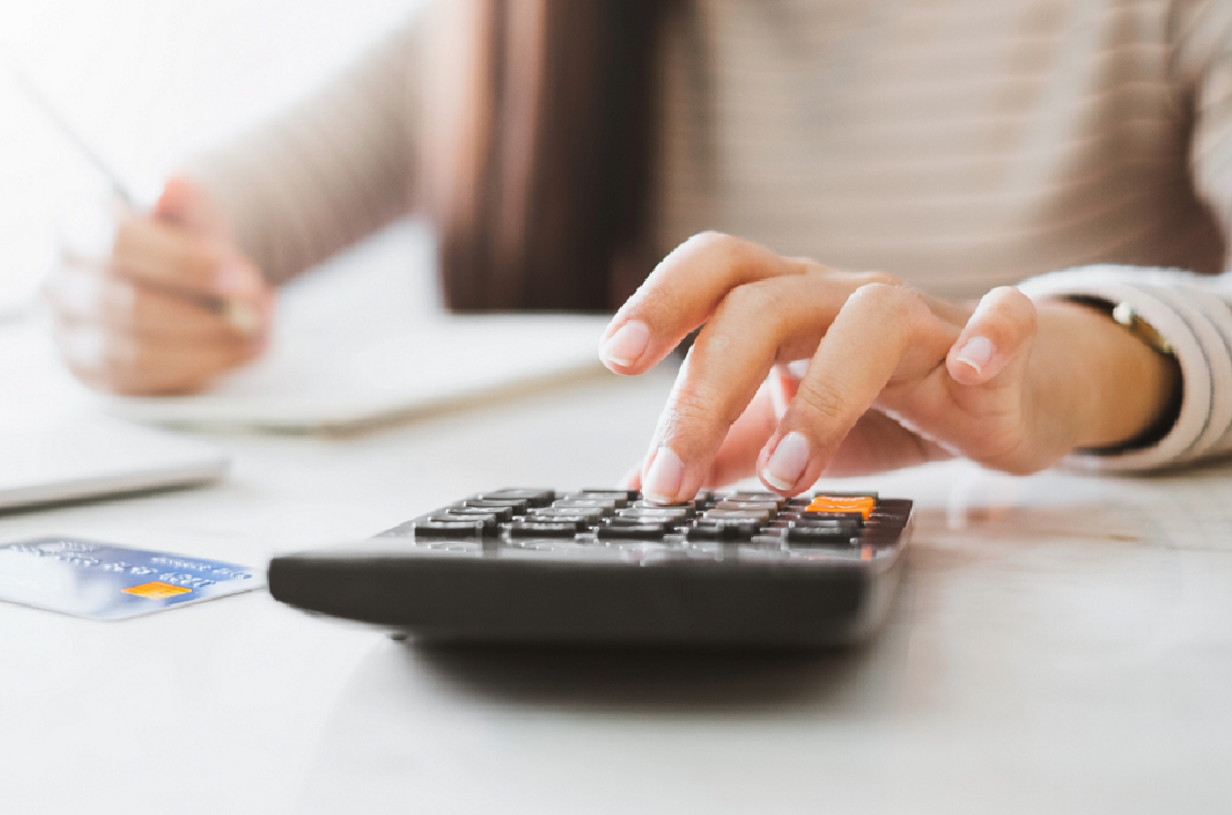 Lady Typing On A Calculator